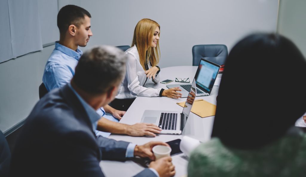 Confident male and female colleagues teambuilding during working process in enterprise