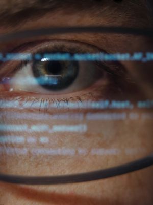 Close-up of programmer with code reflection